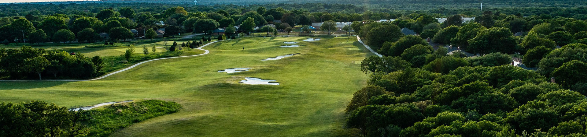 Image of golf ball on tee on grass.